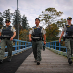 Fay Gin, a fisheries officer on loan from DFO's Steveston's detachment; Derek Chung, former commander of the Annacis Island Whale Protection Unit; and Scotti Griffin, a member of the unit, return to their patrol after lunch on Mayne Island, B.C. Credit: Stefan Labbé/Glacier Media.