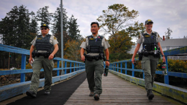 Fay Gin, a fisheries officer on loan from DFO's Steveston's detachment; Derek Chung, former commander of the Annacis Island Whale Protection Unit; and Scotti Griffin, a member of the unit, return to their patrol after lunch on Mayne Island, B.C. Credit: Stefan Labbé/Glacier Media.
