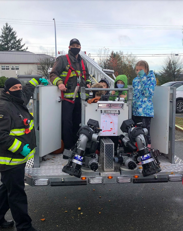 Kids in the bucket with Firefighter Jesse Challoner and Firefighter Josh Fyfe.