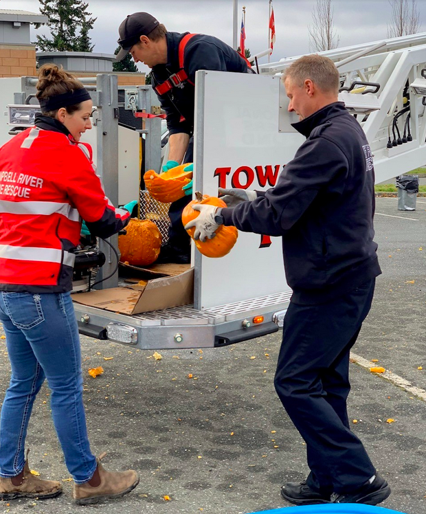 Loading pumpkins with Dispatcher Bonnie Logan, Firefighter Jeremy Fyfe, and Captain Bruce Holbrook.
