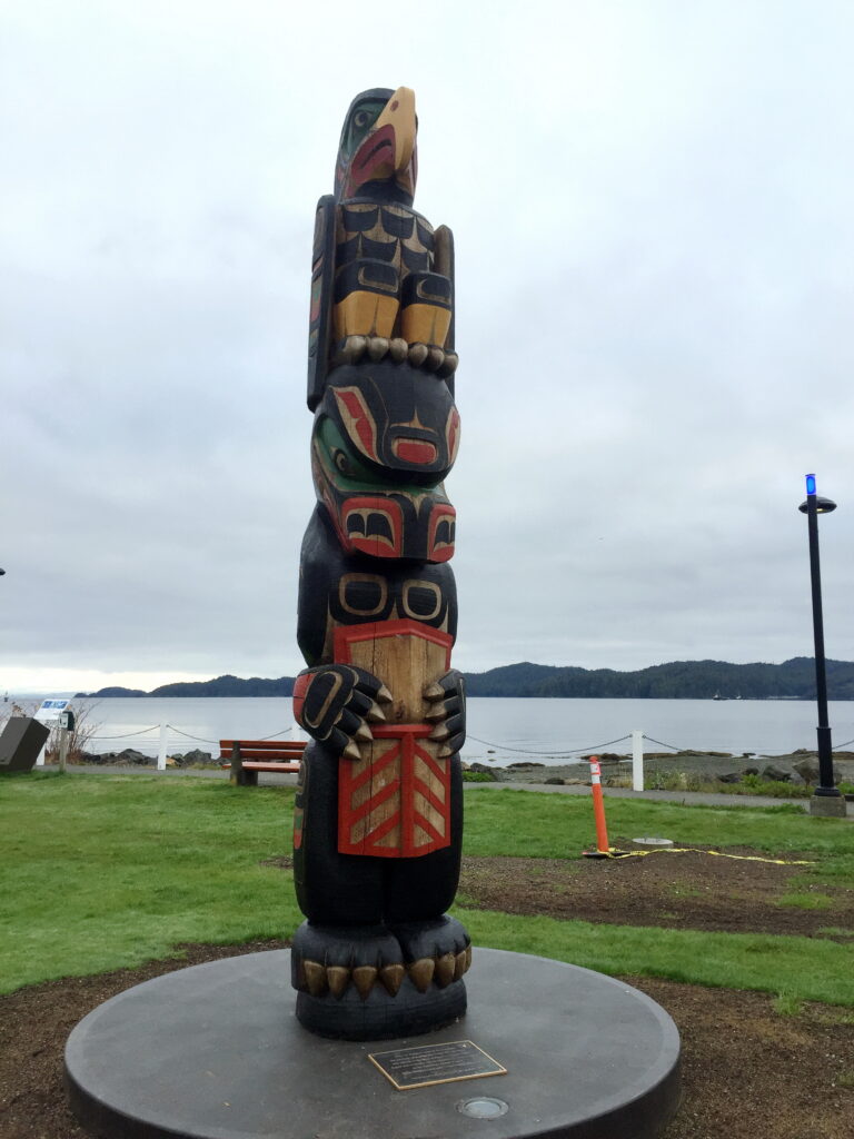 The town center of Port Hardy, British Columbia features war memorials including a totem pole honoring the First Nations War Veterans of WW1, WW2, Korean War, Vietnam, and present-day service members.