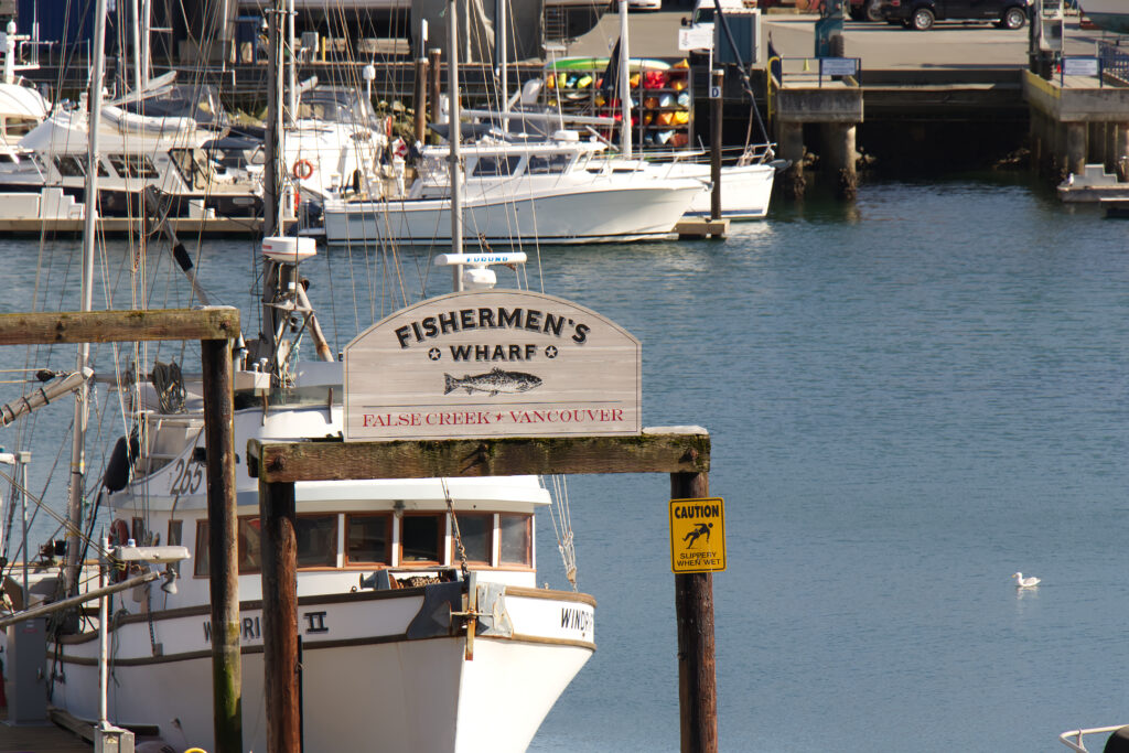 View of sign `Welcome to False Creek Fishermen`s Wharf` in Downtown Vancouver. 