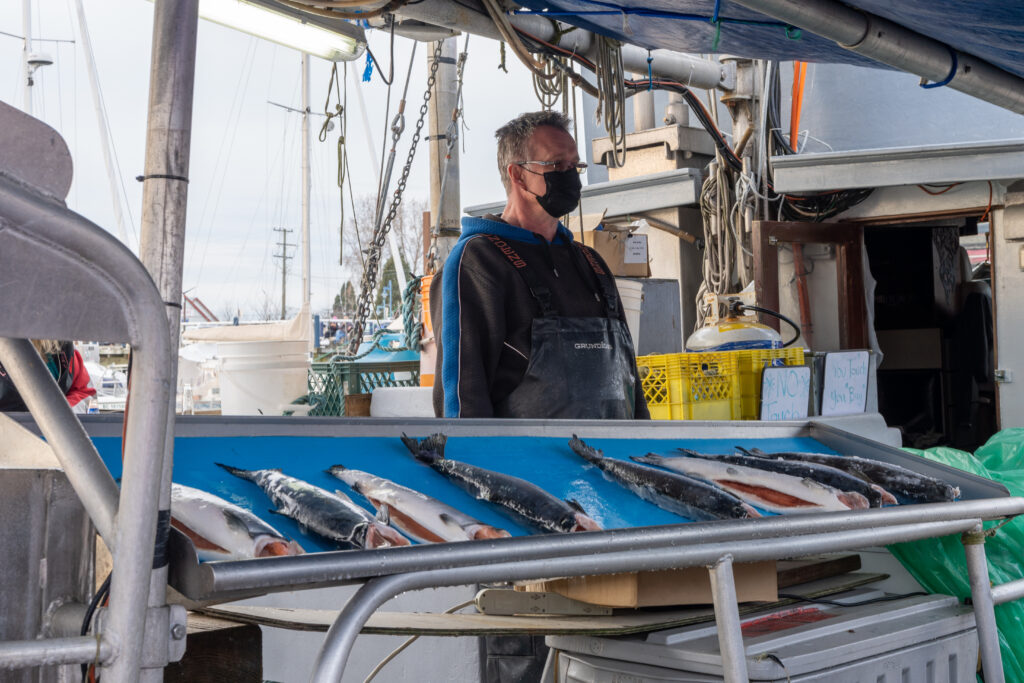  Fishermen sell fish on the boat at Steveston Harbour, B.C.