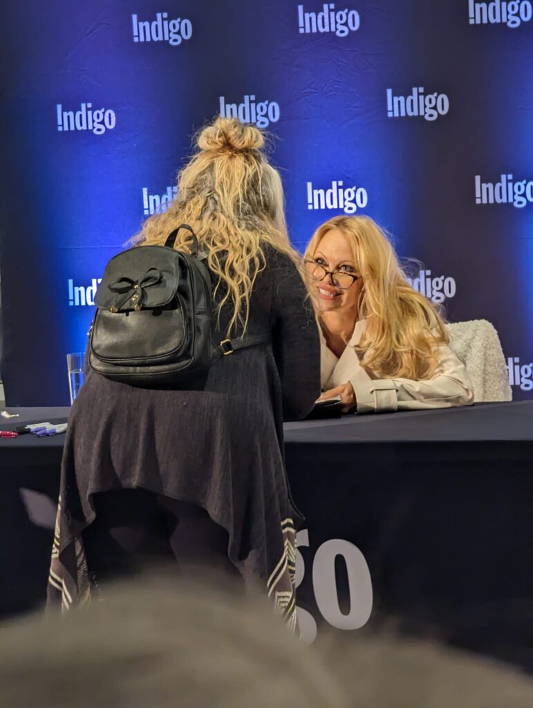 Pamela Anderson signing copies of her book at the Indigo Mayfair bookstore in Victoria.
