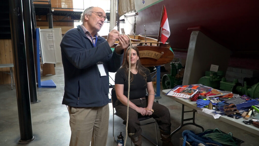 Ruedi shares his expertise in knot-tying with aspiring fishermen at the BC Young Fishermen's Network conference, demonstrating the importance of this timeless skill in the maritime industry.