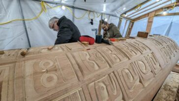 Stan Hunt and his nephew Curtis Dickie working on the Indian Residential School Memorial Monument. This significant project involved the hand-carving of 130 individual faces, representing the children who suffered or never came home from the Indian Residential Schools.