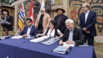 Member of the Kitselas First Nations joined by representatives of the BC government to initial a new treaty.