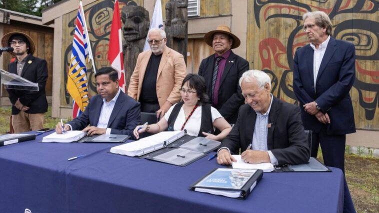 Member of the Kitselas First Nations joined by representatives of the BC government to initial a new treaty.